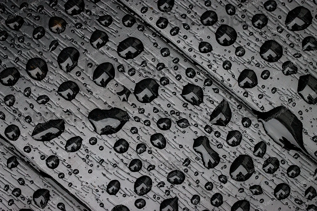 Rain Drops on Dark Surface – Diagonal Patterns in Monochrome — Macro photo by Jos Van De Laar