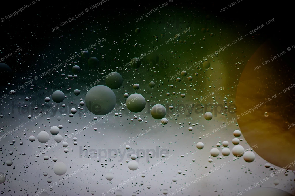 Oil and Water Galaxy — Suspended Bubbles in Dark Green and Gold — Abstract photo by Jos Van De Laar