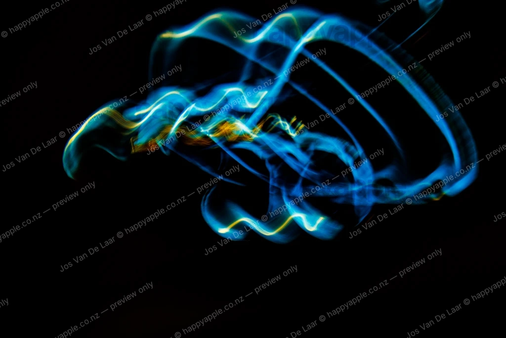 Blue and gold light painting trails on black background — Abstract photo by Jos Van De Laar