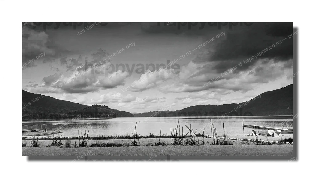 Lake Okataina panorama with dock and storm clouds, New Zealand — Black & White photo by Jos Van De Laar
