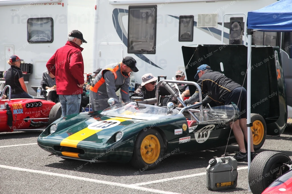 Vintage racing car being serviced in pit lane paddock area — Event photo by Jeff Van de Laar