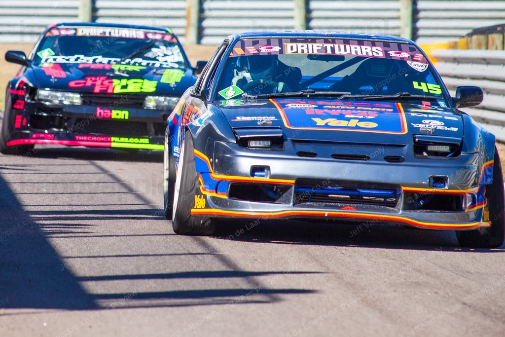 Two drift cars racing on a circuit track during a motorsport event — Automotive photo by Jeff Van de Laar