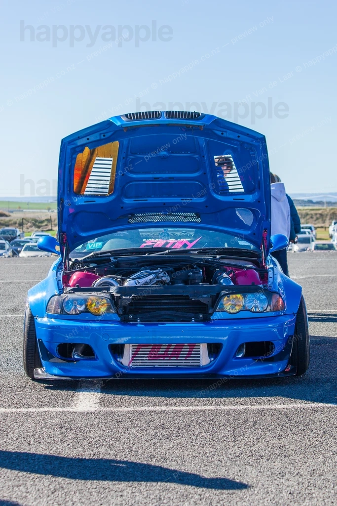 Modified blue car with open bonnet on display at outdoor car show — Automotive photo by Jeff Van de Laar