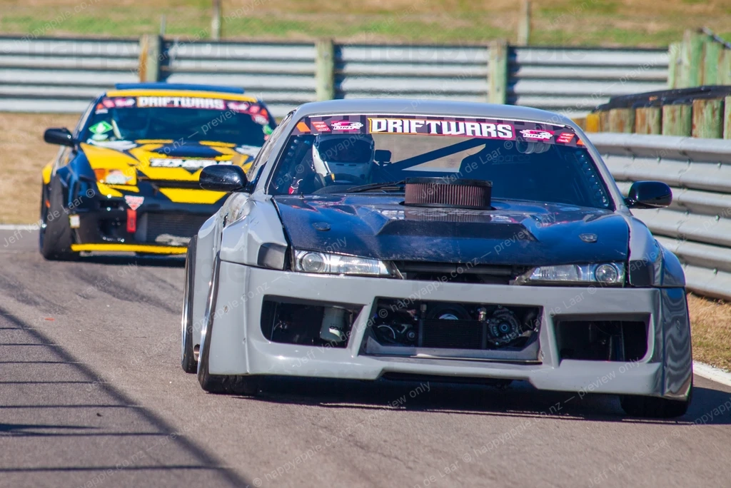 Two modified drift cars racing on a circuit during a drift event — Automotive photo by Jeff Van de Laar
